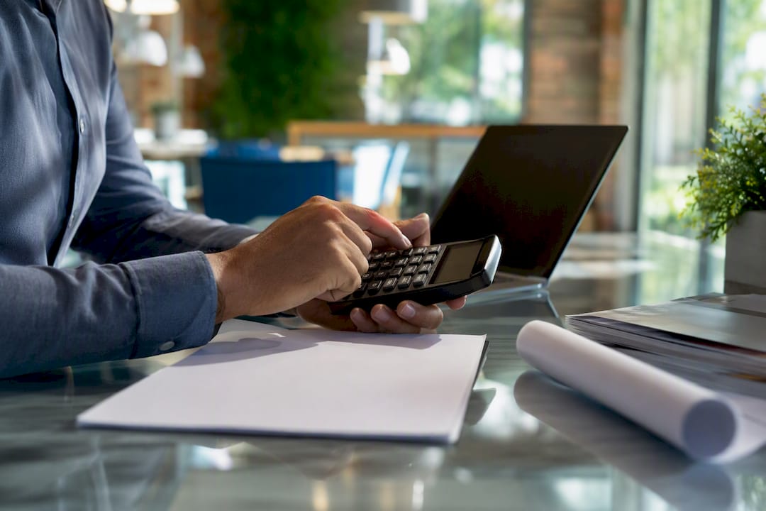 1786989940180_Investor-hands-calculating-loan-points-on-calculator Investor hands calculating loan points on calculator