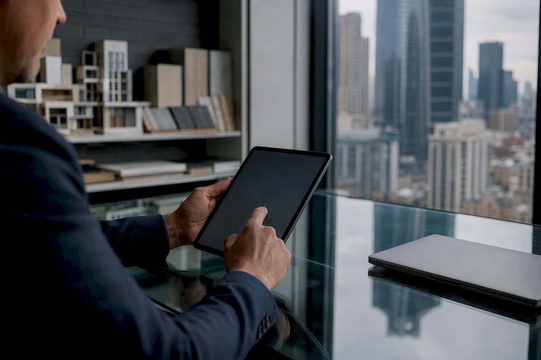 1787888328059_Investor-reviewing-insurance-details-on-tablet Investor reviewing insurance details on tablet